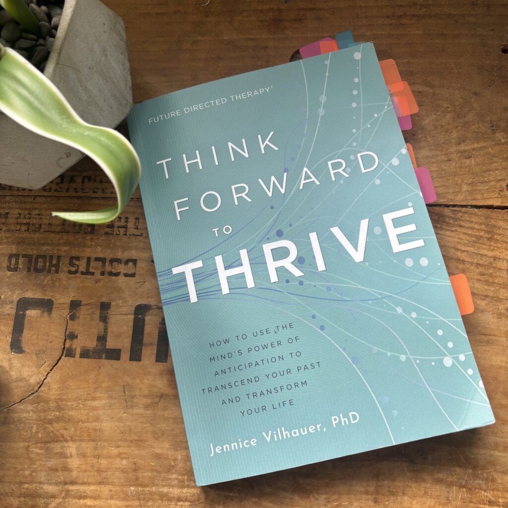 Flat lay of Think Forward to Thrive by Jennice Vilhauer, PhD, for a blog review on intentional living and mindset change.